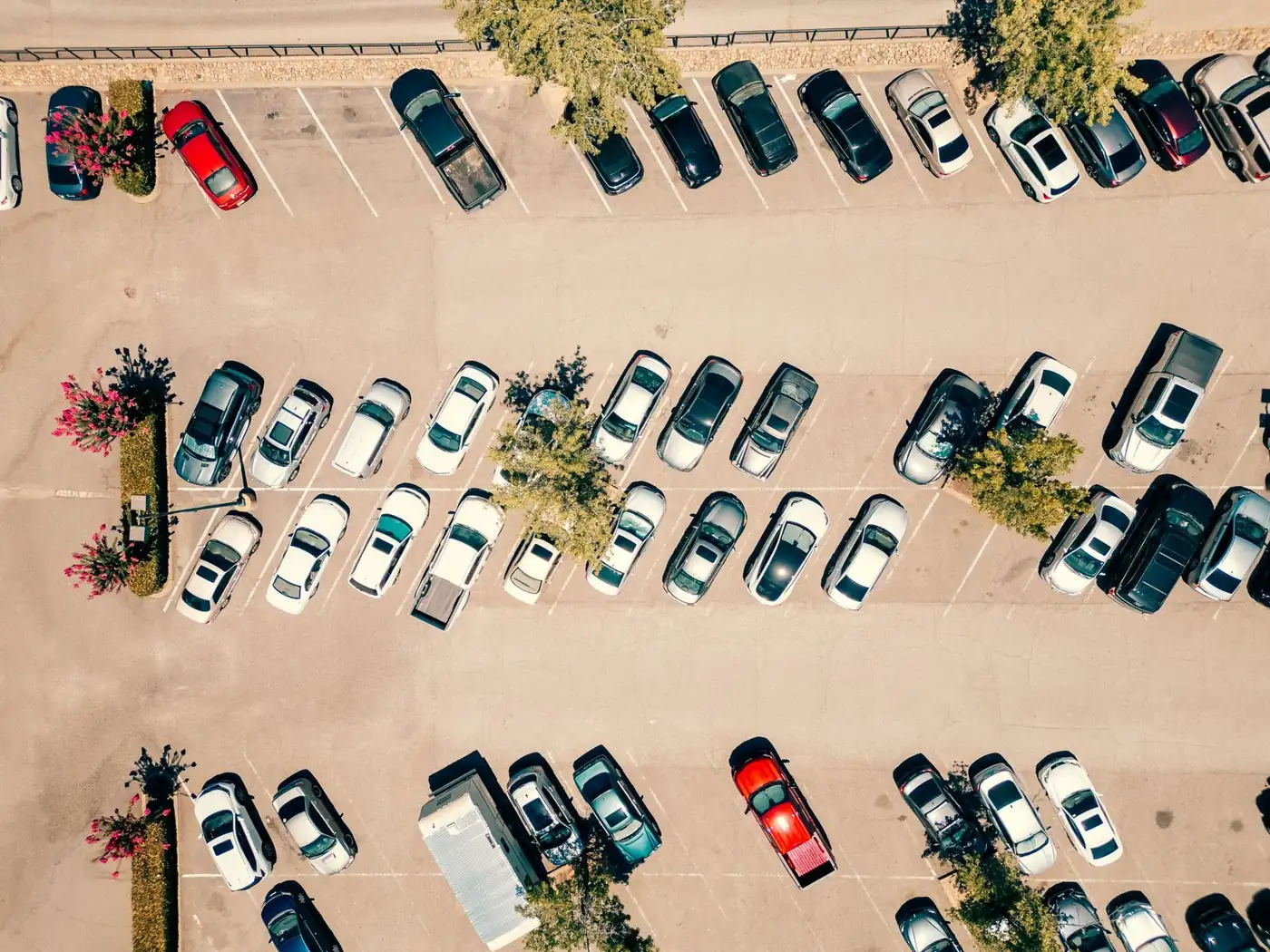 Aerial view of a busy parking lot with desert landscaping islands