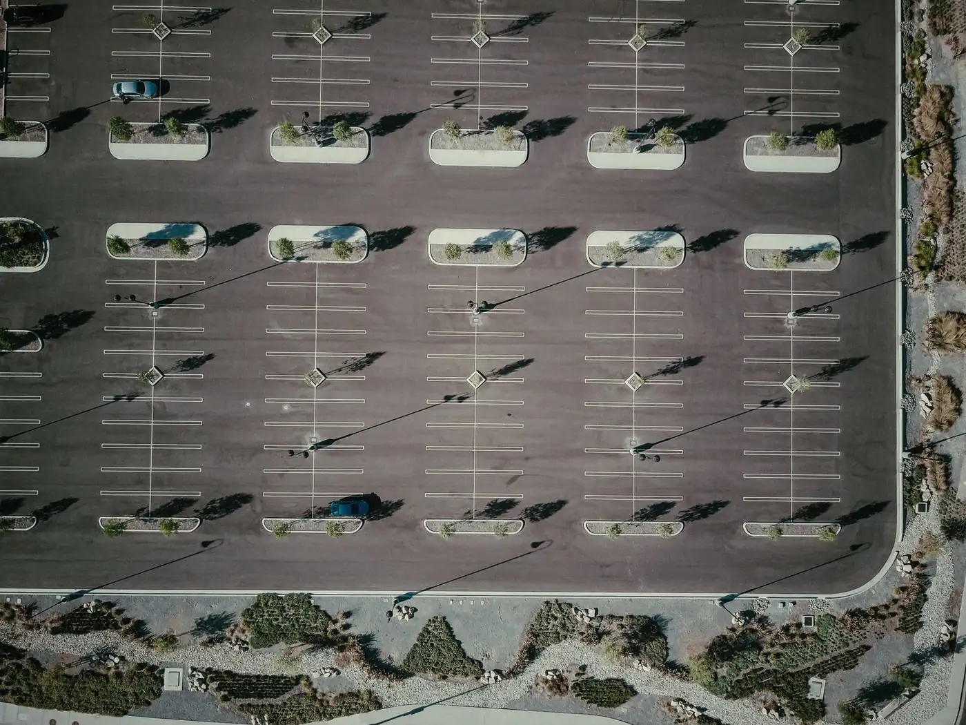 Aerial view of a large commercial parking lot with shade structures