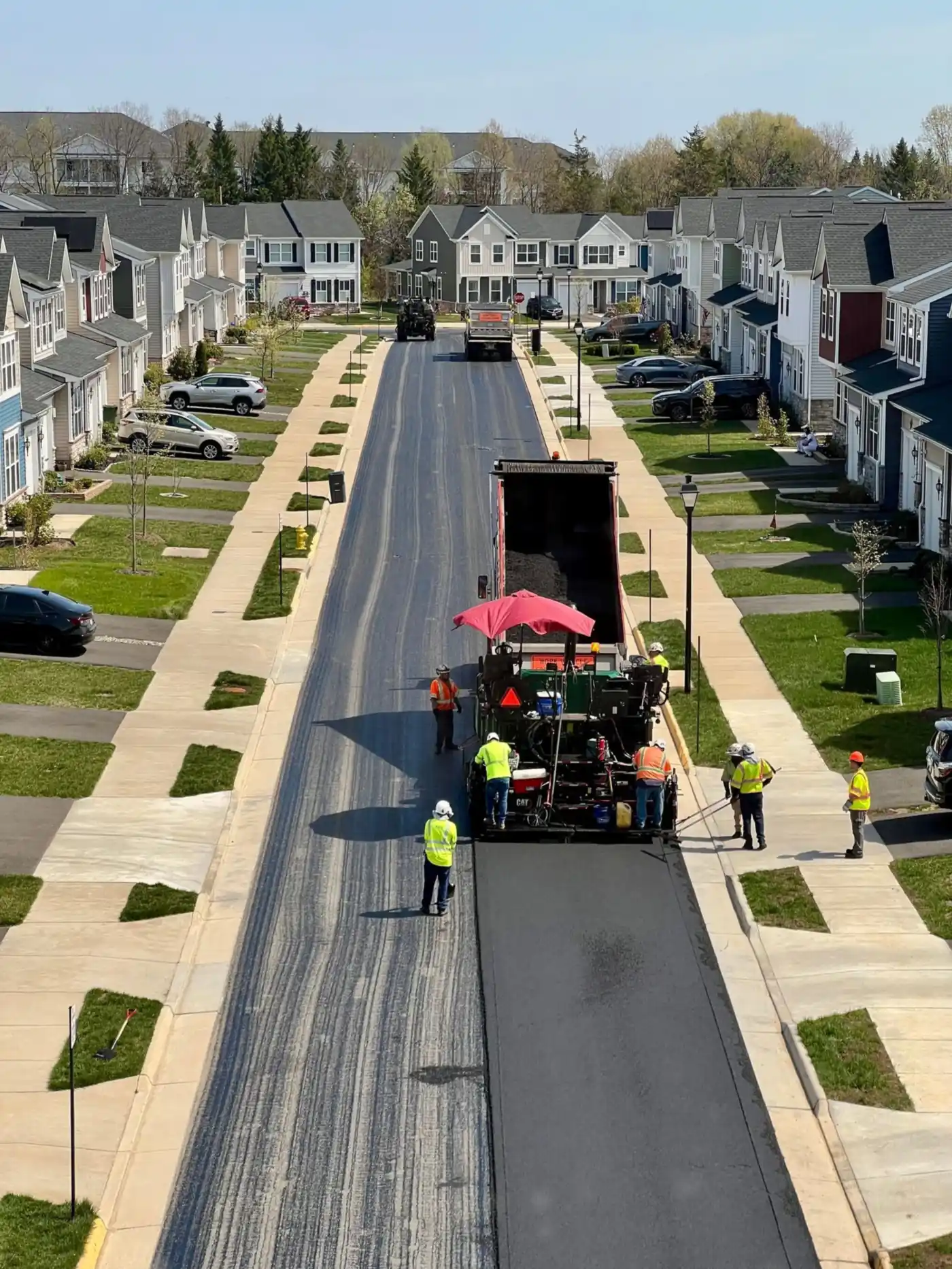 Paving crew laying new asphalt on a residential street